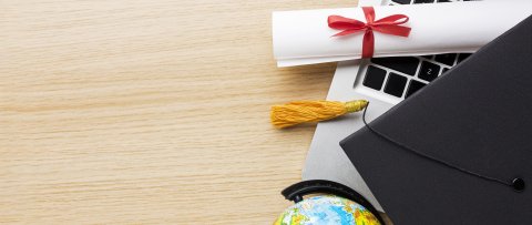 top-view-globe-with-academic-cap-laptop
